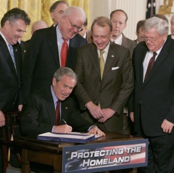 TOUGH ACT TO FOLLOW: Surrounded by members of Congress and Cabinet members, then President George W. Bush signs The USA PATRIOT and Terrorism Prevention Re-authorization Act of 2005. The Act had come under criticism from some in Congress for the potential to infringe of civil liberties but was pushed by the Bush administration as essential for fighting terrorism. (Mark Wilson/Getty Images)