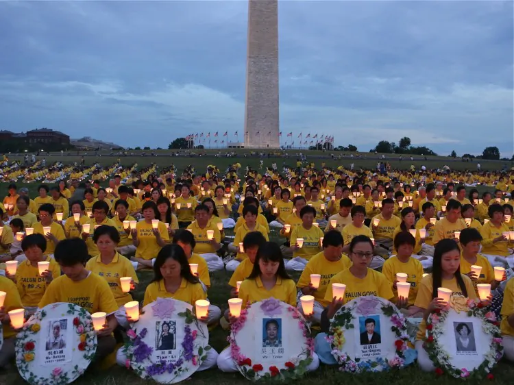 D.C. July 2012. Falun Gong practitioners hold candles to honor the thousands who have died in the Chinese regime's persecution of the peaceful meditation practice. Seen from above, they form the shape of the Chinese characters for truthfulness, compassion, and tolerance, the key principles of the practice. (Lisa Fan/The Epoch Times)