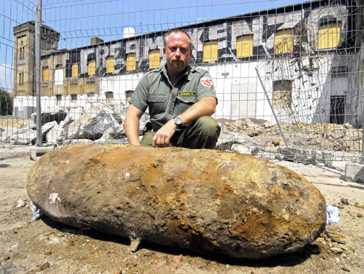 Manuel Kunzendorf, a police bomb disposal expert, poses with a 500-pound bomb dating from World War II, that he deactivated on July 21, 2006, in Potsdam, Germany. Hundreds of thousands of unexploded bombs from World War II remain buried in German soil. (Theo Heimann/AFP/Getty Images)