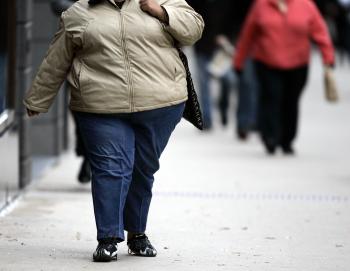A women walks down the street on Michigan Avenue 19 October, 2006 in Chicago, Illinois. (Jeff Haynes/AFP/Getty Images)