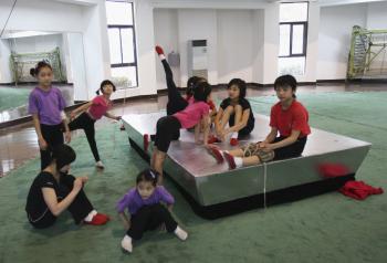 Young Chinese acrobats resting after training. In China enormous emphasis and funding are being given to elite sports, while neglecting sporting activities for the masses. The overall health of Chinese youth is in decline with the average fitness and health-related expenditure for a Beijing resident is only 73 yuan, ($11 US). (Getty Images )