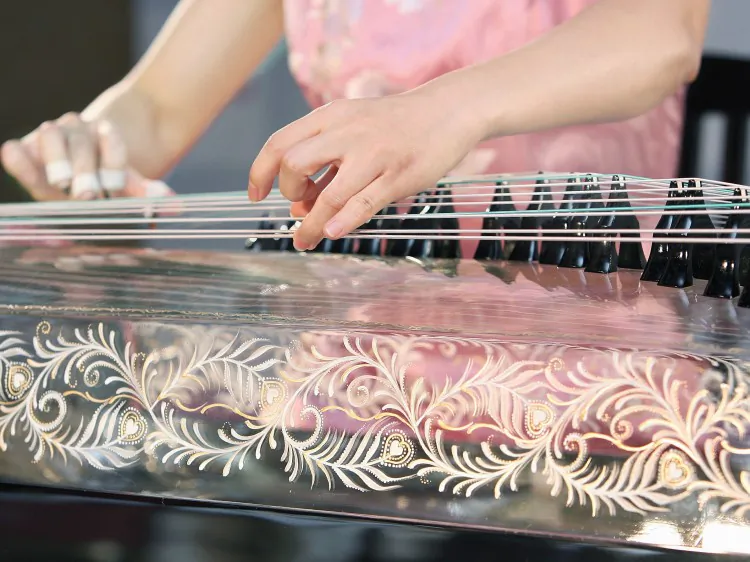 A Chinese woman plays the Gu Zheng. (Toru Yamanaka/AFP/Getty Images)