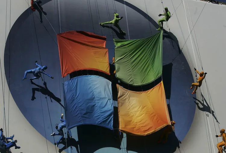 Members of the "Grounded Aerial Dance Theater" hang from ropes and dance on a poster promoting Vista, a new version of Microsoft Windows, on the side of a warehouse building on Manhattan's west side January 29, 2007 in New York. (Chris Hondros/Getty Images)