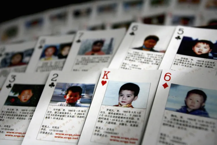 BEIJING, CHINA: The "missing children playing cards" are displayed by Shen Hao, the founder of a missing person website, the www.xrqs.com, on March 31, 2007 in Beijing, China. The cards show photographs, informations of 27 missing children and Shen Hao plans to hand out them free to the public security departments, civil affairs bureaus and residents, in areas notorious for child trafficking. (China Photos/Getty Images)