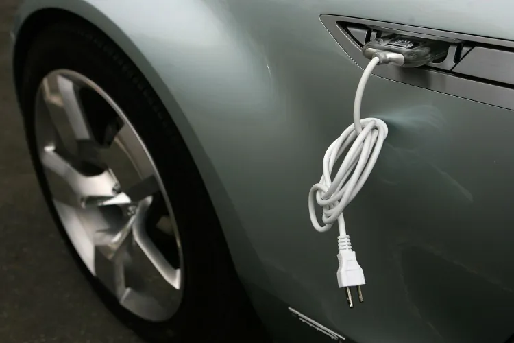 An electric cable is attached to the side of a Chevrolet Volt vehicle during a viewing on Capitol Hill in this file photo. Most EV drivers spend about $30 on electricity with an averaging 1,050 miles per month, which is a growing alternative to rising gas prices. (Alex Wong/Getty Images)
