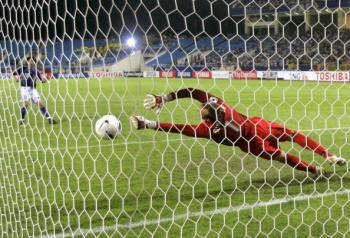 Japanese Shunsuke Nakamura (L) scores as Australian goalkeeper Mark Schwarzer (R) attempts to save the ball during their quarter-final match of the Asian Football Cup in Hanoi, July 21 2007. Japan won a tense 5�4 penalty shootout to beat a desperately u (Liu Jin/AFP/Getty Images )