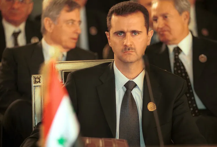 Syrian President Bashar Al Assad sits at a desk at the Arab Summit March 27, 2002 in Beirut, Lebanon. (Courtney Kealy/Getty Images)