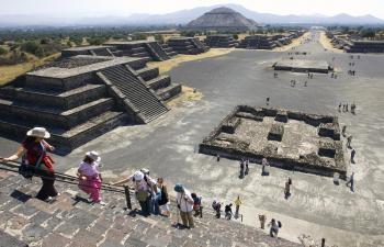 Tourists visit the Pyramid of the Moon at the archaeological site of Teotihuacan, Jan. 28, 2008. Archeologists announced Aug. 3 that they have found a tunnel and tomb that may provide the first clues into the city's unknown rulers. (Ronaldo Schemidt/AFP/Getty Images)