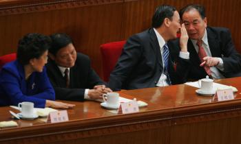 Former Communist Party secretary of Xinjiang Wang Lequan on the right, at the seventh plenary session of the National People's Congress (NPC), in Beijing, March 2008. He stepped down after mass demonstrations recently. (Feng Li/Getty Images)