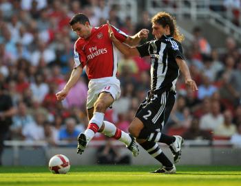 Arsenal striker Robin van Persie (left) fights off Newcastle's Fabrizio Coloccini. He scored two goals in a 3–0 win against Newcastle on Saturday. ( Shaun Botterill/Getty Images) Arsenal striker Robin van Persie (left) fights off Newcastle's Fabrizio Coloccini. He scored two goals in a 3–0 win against Newcastle on Saturday. ( Shaun Botterill/Getty Images)