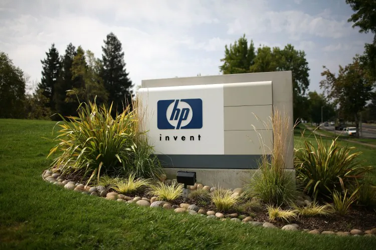 The Hewlett-Packard logo is displayed on the entrance to the HP Headquarters in Palo Alto, Calif. The company is one of the world’s biggest makers of PCs and printers, and now those units will become one. (Photo by Justin Sullivan/Getty Images)