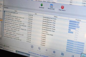 DOWNLOAD: A picture taken on March 2009 in Paris shows the screen of a computer showing a web site of downloading contents. Internet users who illegally download movies or music could be slapped with tough penalties. (Caroline Ventezou/Getty Images )
