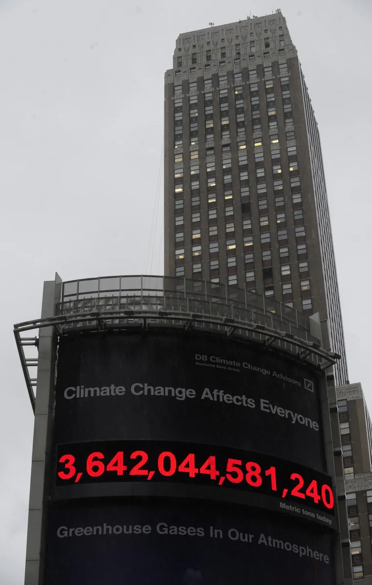 Rain falls in front of the world's frst real-time carbon counter which displays greenhouse gases amount in the atmosphere, after it was unveiled by Deutsche Bank in New York, June 18, 2009. Deutsche Bank launched the world's first scientifically valid, real-time carbon counter, a nearly 70-foot (21.3-meter) tall digital billboard displaying the running total of long-lived greenhouse gases in the atmosphere. (EMMANUEL DUNAND/AFP/Getty Images)