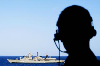 A crew member from the Dutch frigate Hr. Ms. Evertsen, looks at sea as his vessel receives a component from the Navarinon (F461) of the Greek navy, in the Indian Ocean on Sep. 19. (ROBIN UTRECHT/AFP/Getty Images)