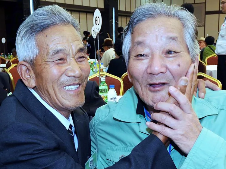 South Korean Lee Jung-Ho (R) reunites with his North Korean elder brother Lee Kwae-Seok (L) who joined the South Korean military and was taken prisoner by North Korea during the Korean War, on September 27, 2009 at the Mount Kumgang resort in North Korea. (Pool/Getty Images)