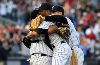 DIVISION CHAMPS: Mariano Rivera, Jose Molina, and Mark Teixeira celebrate after defeating Boston and clinching the AL East. (Jim McIsaac/Getty Images)