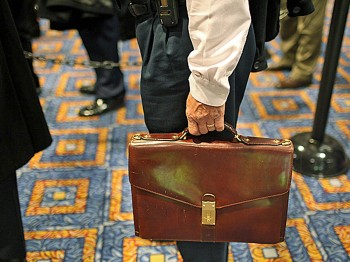 A man holds his briefcase while in line at a job fair sponsored by Monster.com that attracted hundreds of people on November 6, 2009 in New York City. (Spencer Platt/Getty Images)