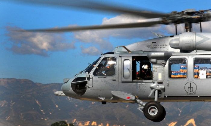A U.S. SH-60 Seahawk helicopter, one of the aircraft said to have counterfeit parts, is shown flying over Haiti.  (Daniel Barker/U.S. Navy via Getty Images)