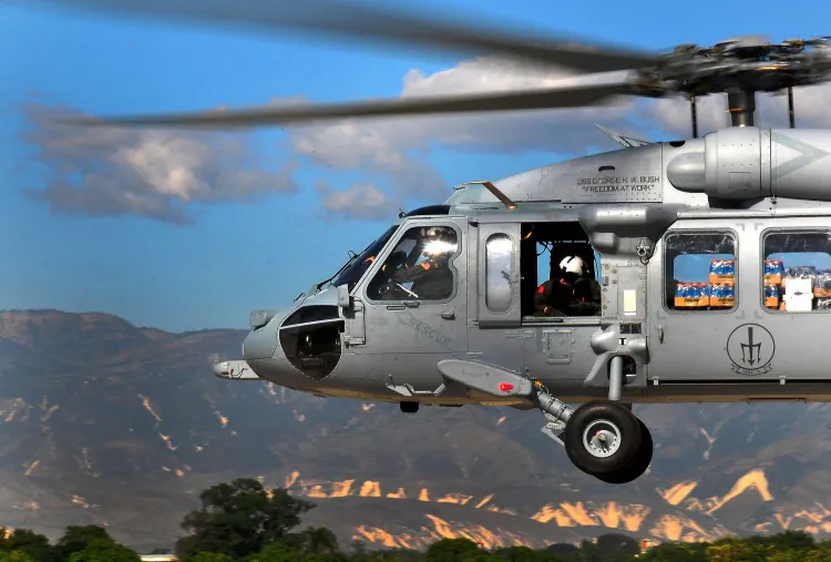 A U.S. SH-60 Seahawk helicopter, one of the aircraft said to have counterfeit parts, is shown flying over Haiti.  (Daniel Barker/U.S. Navy via Getty Images)
