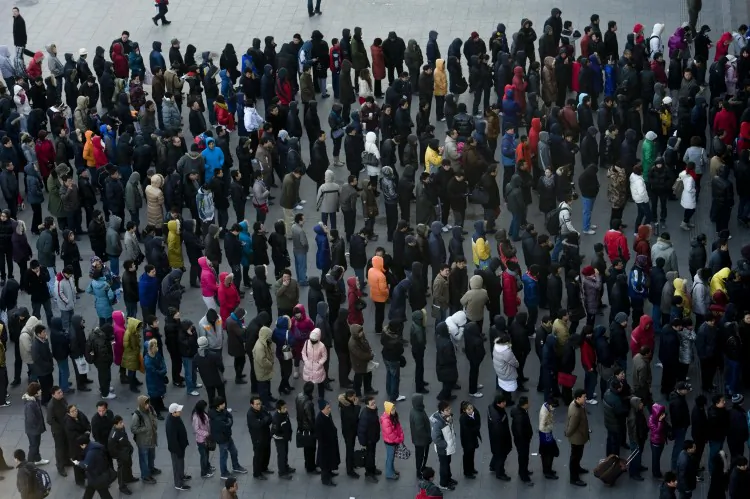 People in Beijing line up to buy tickets at a train station. (STR/AFP/Getty Images)