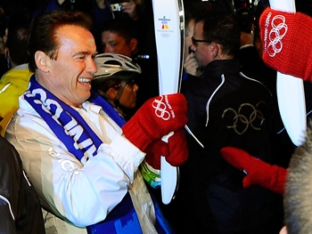 California Governor Arnold Schwarzenegger lights the Olympic flame from a runner as he prepares to run with the torch during the Olympic torch relay ahead of the Vancouver 2010 Winter Olympics on February 12, 2010 in Vancouver, Canada. (Kevork Djansezian/Getty Images) California Governor Arnold Schwarzenegger lights the Olympic flame from a runner as he prepares to run with the torch during the Olympic torch relay ahead of the Vancouver 2010 Winter Olympics on February 12, 2010 in Vancouver, Canada. (Kevork Djansezian/Getty Images)