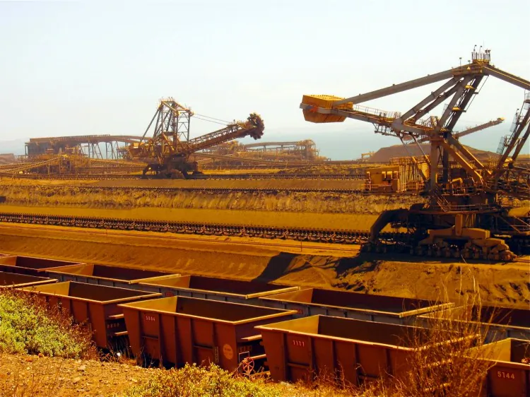 This photo taken in 2010 shows remote-controlled stackers and reclaimers moving iron ore to rail cars at Rio Tinto's Port Dampier operations in Western Australia's Pilbara region. (Amy Coopes/AFP/Getty Images)