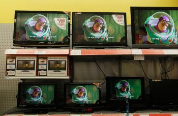 PURSUING STUFF: Flat screen televisions for sale are seen at a retail store April 30 in New York.  (Chris Hondros/Getty Images)