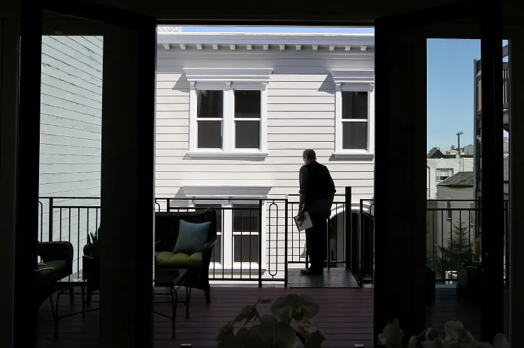 A real estate agent tours a home for sale during an open house in San Francisco. According to real esate agents, in the current market environment, not having inside knowledge will prevent people from getting the house they desire. (Justin Sullivan/Getty Images)