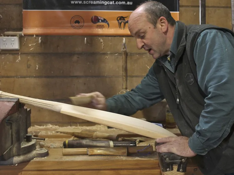 Craftsman Julian Milichamp sands a cricket bat during the handmade manufacture of cricket bats, known as 'podshaving' in his home studio on May 12, 2010, in Drysdale, Australia. (Robert Cianflone/Getty Images)