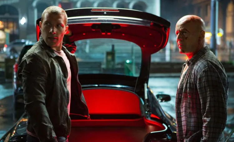 Jack McClane (Jai Courtney) (L) and his dad John McClane (Bruce Willis) (R) prepare for battle in the action-thriller “A Good Day to Die Hard.” (Frank Masi/Twentieth Century Fox Film Corporation)