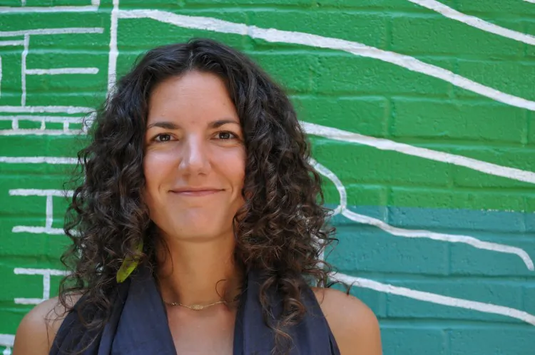 Anne Frederick, the executive director of Hester Street Collaborative (HSC), poses in front of their community design at the Dr. Sun Yat Middle school. (Courtesy of Hester Street Collaborative)