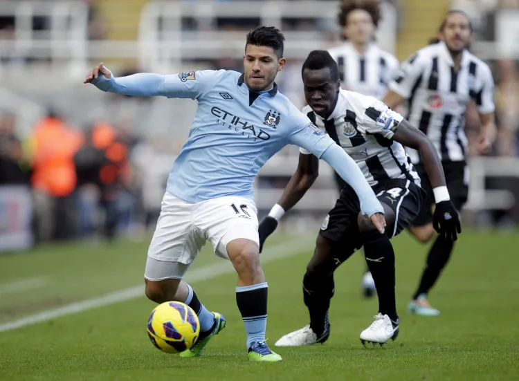 Manchester City’s Sergio Aguero fends off Newcastle’s Cheik Tiote in English Premier League action on Saturday, Dec. 15, 2012. (Graham Stuart/AFP/Getty Images)