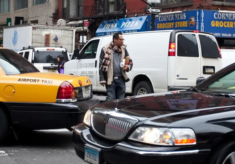 A Pedestrian in Midtown Manhattan walks across the street on Feb. 15. (Amal Chen/The Epoch Times)