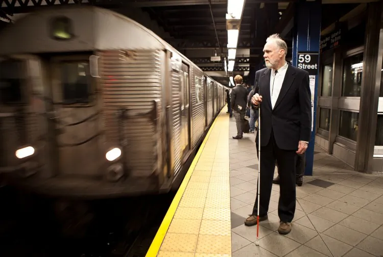 Karyl Berger shows how the color contrast of the buttons on the MTA’s new pilot help-point stations could be improved to assist the visually impaired. (Amal Chen/Epoch Times)