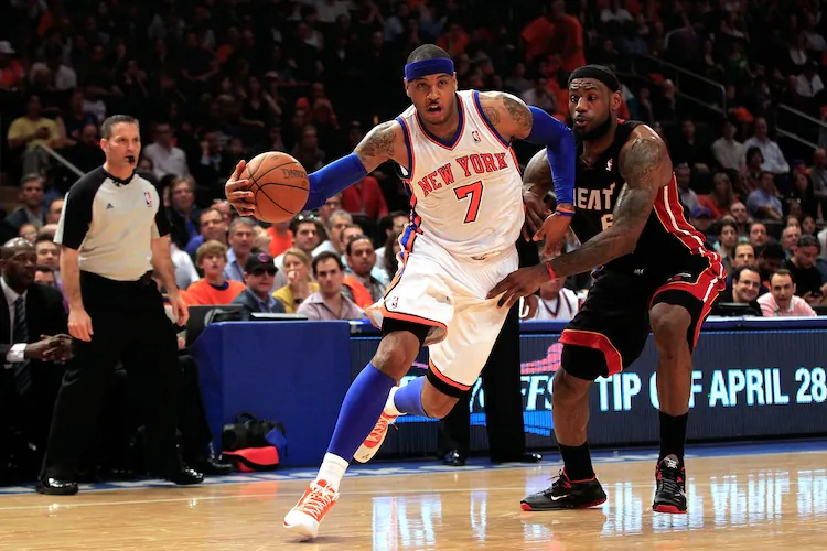 Carmelo Anthony (L) outscored LeBron James (R) 42–29 but LeBron's Heat won 93–85. (Chris Trotman/Getty Images)
