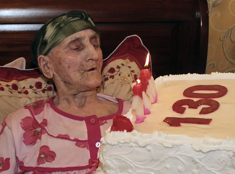 Georgian woman Antisa Khvichava blowing out candles on her cake during her 130th birthday party in the village of Sachino, some 370 km (230 miles) west of Tbilisi July 8, 2010. Khvichava is purported to be the oldest person in the world. (STRINGER/AFP/Getty Images)