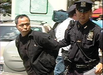 New York City police arrest a pro-communist supporter in Flushing, May 2008. More than a dozen arrests were made during attacks on Falun Gong practitioners by the pro-communist supporters. (The Epoch Times) New York City police arrest a pro-communist supporter in Flushing, May 2008. More than a dozen arrests were made during attacks on Falun Gong practitioners by the pro-communist supporters. (The Epoch Times)