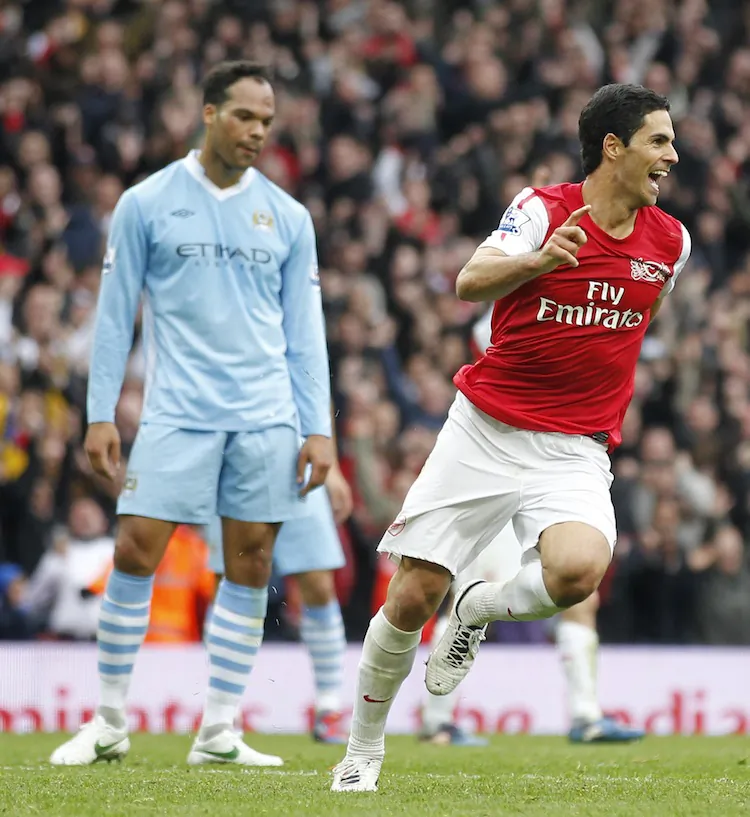 Arsenal’s Mikel Arteta celebrates his winning goal as Manchester City’s Joleon Lescott looks on glumly. (Ian Kington/AFP/Getty Images)