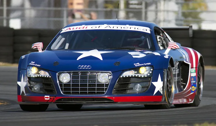 The new Audi R8 Grand Am, in its distinctive flag livery, at speed at Daytona International Speedway. (Audi Motorsport)
