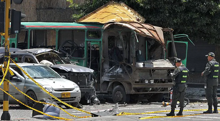 Police officers inspect the wreckage of vehicles after a bomb attack on the motorcade of Colombia's former Interior and Justice Minister (2002-2004) Fernando Londono. The ex-minister was injured and two people were killed in the attack. (Guillermo Legaria/AFP/GettyImages)