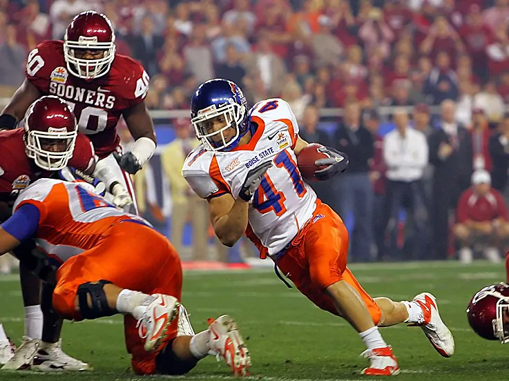 Quarterback Colt McCoy (12) of the Texas Longhorns scrambles from Thaddeus Gibson (90) of the Ohio State Buckeyes in the Tostitos Fiesta Bowl Game on January 5, 2009. (Jed Jacobsohn/Getty Images)