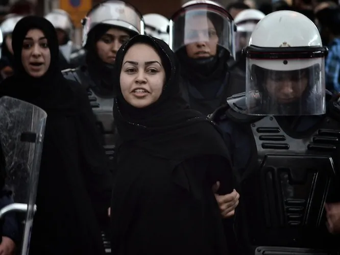 A Bahraini Shiite protester is detained by riot police during an anti-government demonstration in the center of the capital Manama on Sept. 21. (Mohammed al-Shaikh/AFP/GettyImages)