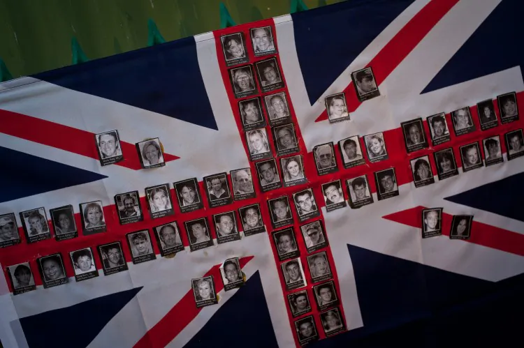 An Australian flag made up of photographs of victims of the 2002 bomb blast is seen on a fence at the site of the Sari Club in Jalan Legian, Bali, on Oct. 10, 2012. Many relatives and foreign tourists have begun to arrive to take part in ceremonies marking the 10th anniversary of the bomb attack in the Kuta tourist district. (Chris McGrath/Getty Images)