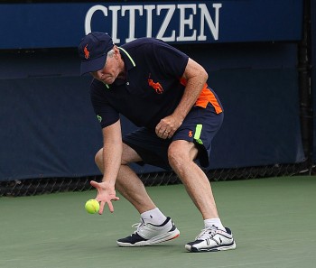 NIMBLE FINGERS: Loughran crouches to snare an errant ball during a US Open match. He credits yoga for keeping him flexible. (Gary Du/The Epoch Times) NIMBLE FINGERS: Loughran crouches to snare an errant ball during a US Open match. He credits yoga for keeping him flexible. (Gary Du/The Epoch Times)