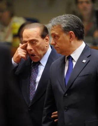 Former Italian Prime Minister Silvio Berlusconi (L) touches his eyes, 2011. He is currently in the hospital being treated for a recurring eye problem. (Eric Feferberg/AFP/Getty Images)