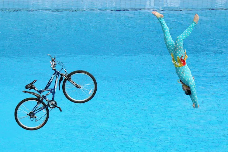 A performer falls with a bicycle after riding it off the 10-meter diving platform on day two of the FINA/Midea Diving World Series 2012 on Friday, March 24, at the National Aquatics Center in Beijing, China. China’s Bo Qui won the men’s 10-meter platform competition while fellow countryman Ruolin Chen won the women’s 10-meter platform competition. (Feng Li/Getty Images)