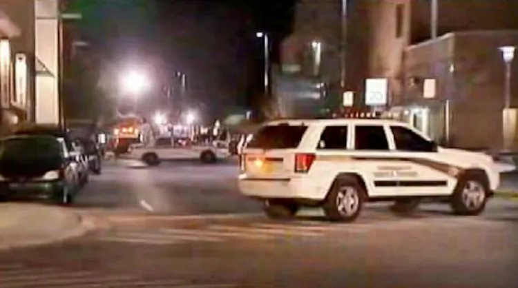 Police vehicles stand outside a University of Central Florida student residence building in this screen shot of a Fox News broadcast, as police investigate the suicide at the residence and explosives found in the deceased man's room.