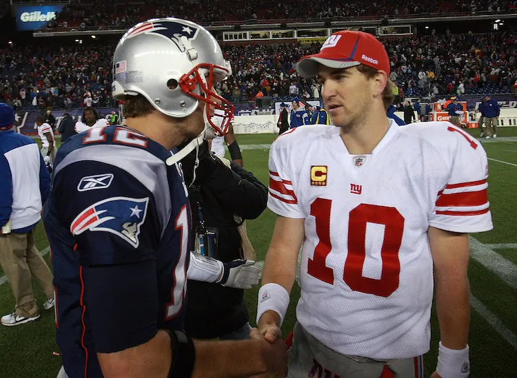 Eli Manning (R) and the Giants hope for a repeat of this season's 24-20 win against Tom Brady (L) and the Patriots. (Jim Rogash/Getty Images)