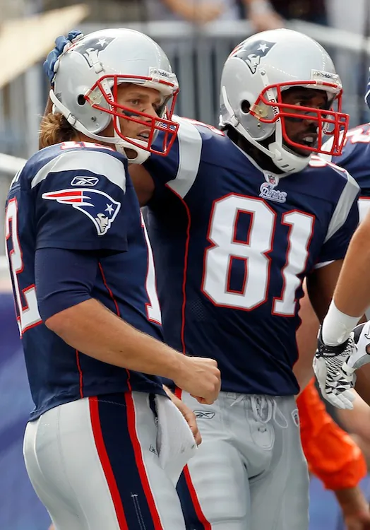 Randy Moss (right) was the main reason behind two of the greatest teams in NFL history. In 2007 with Tom Brady (left) the duo broke single-season passing and receiving touchdown records. (Jim Rogash/Getty Images)