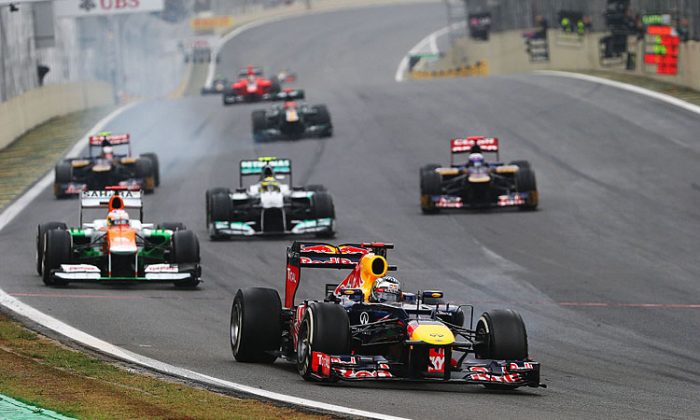 Sebastian Vettel of Red Bull Racing leads a train of cars through Turn One during the Formula One Brazilian Grand Prix, November 25, 2012. Vettel will be back with Red Bull, according to the official 2013 F1 roster. (Mark Thompson/Getty Images)